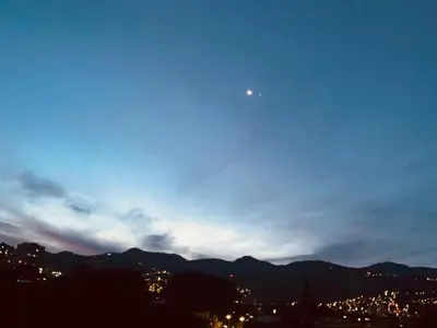 a view of a city at night with the sky at Habitaciónes en Casa Ithaca en Floresta - Santa Lucía in Medellín