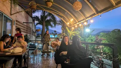 a group of people sitting at tables in a restaurant at Beautiful Central Apartment in Sabaneta