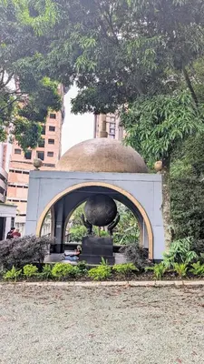 a statue of a large object in front of a building at Beautiful Central Apartment in Sabaneta