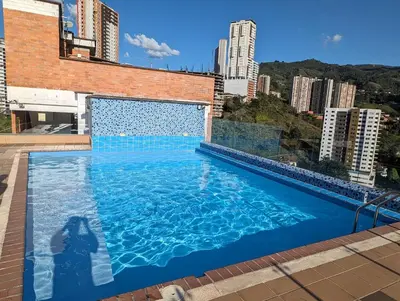 a large swimming pool on top of a building at Beautiful Central Apartment in Sabaneta