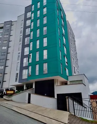 a green building on the side of a street at Cálido mini apartamento in Manizales