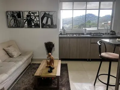 a living room with a monkey statue on a coffee table at Cálido mini apartamento in Manizales