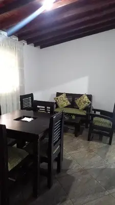 a dining room with two benches and a table and chairs at EpicBK Casa Campestre en San Pedro Antioquia in Zatra Tobón