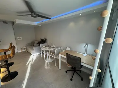 a living room with a table and a couch at Luxury Apartment Jacuzzi Air Conditioning Fireplace and King Bed in Medellín