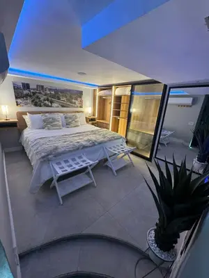 a bedroom with a large bed on a balcony at Luxury Apartment Jacuzzi Air Conditioning Fireplace and King Bed in Medellín