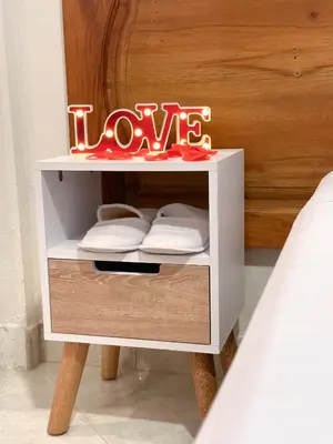 a white nightstand with a sign that says love at Hostal Rose Moor in Jardin