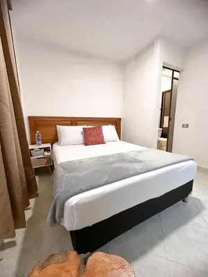 a bedroom with a large bed in a room at Hostal Rose Moor in Jardin