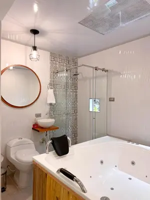 a bathroom with a tub and a toilet and a sink at Hostal Rose Moor in Jardin