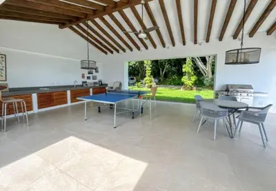 a living room with a ping pong table and chairs at Casa finca Pool & Jacuzzi, Tropical Oasis in Jericó