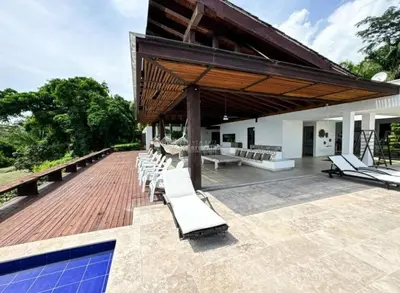 a group of white lounge chairs on a patio at Casa finca Pool & Jacuzzi, Tropical Oasis in Jericó