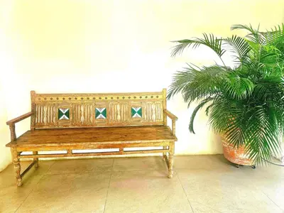 a wooden bench sitting next to a potted plant at Casa finca Pool & Jacuzzi, Tropical Oasis in Jericó