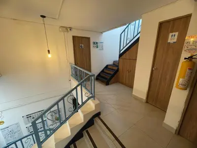 a staircase in a building with two doors and a stair case at Habitación individual privada con baño privado y desayuno in Medellín