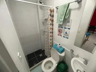 a small bathroom with a toilet and a sink at Habitación individual privada con baño privado y desayuno in Medellín