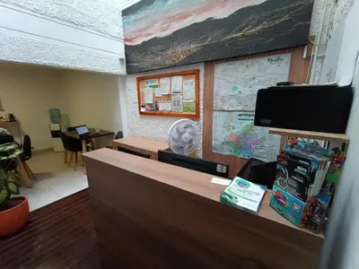 an office with a reception desk with a map at Habitación individual privada con baño privado y desayuno in Medellín