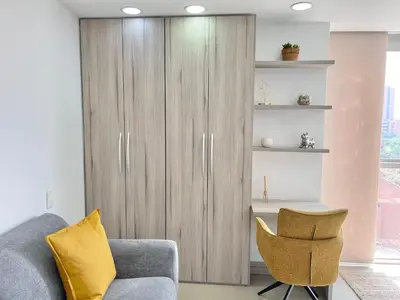 a living room with a couch and a chair at Modern furnished loft in el Poblado in Medellín