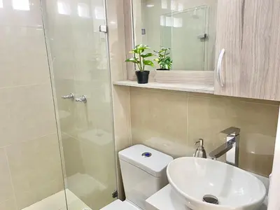 a bathroom with a shower and a toilet and a sink at Modern furnished loft in el Poblado in Medellín