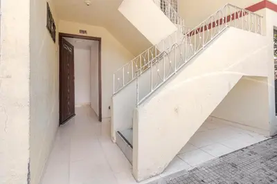 a staircase in a house with a door and a hallway at Casa de las Flores en Medellín in Medellín