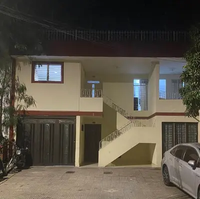a house with a staircase and a car parked in front at Casa de las Flores en Medellín in Medellín
