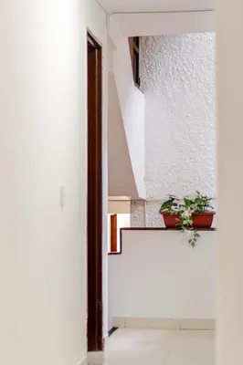 a staircase in a house with a potted plant at Casa de las Flores en Medellín in Medellín