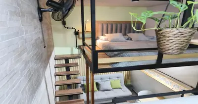 a room with two bunk beds and a stairway with a bed at Zen Hausinn Cozy Studio - Poblado Medellin in Medellín
