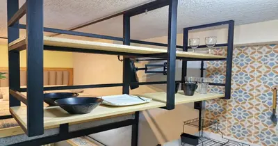 a kitchen with a bunk bed with wine glasses at Zen Hausinn Cozy Studio - Poblado Medellin in Medellín