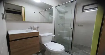 a bathroom with a toilet and a glass shower at Zen Hausinn Cozy Studio - Poblado Medellin in Medellín