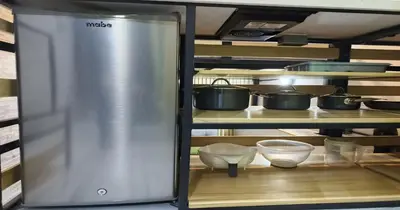 a refrigerator in a kitchen with pots and pans at Zen Hausinn Cozy Studio - Poblado Medellin in Medellín