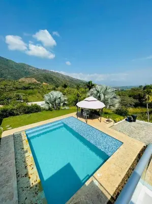 a pool with a table and a gazebo at Paraíso in San Jerónimo