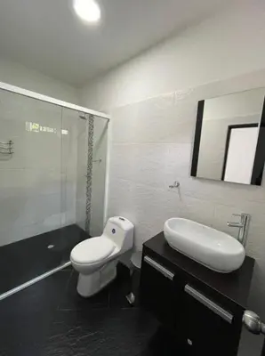 a bathroom with a toilet and a sink and a mirror at Paraíso in San Jerónimo