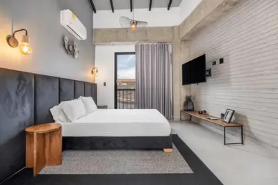 a bedroom with a large bed and a television at Poblado, 5 min to San Lucas Plaza, Free parking 315 in Medellín