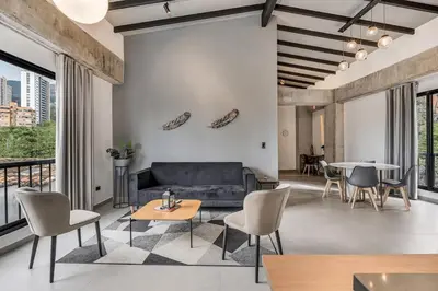 a living room with a couch and chairs and a table at Poblado, 5 min to San Lucas Plaza, Free parking 315 in Medellín