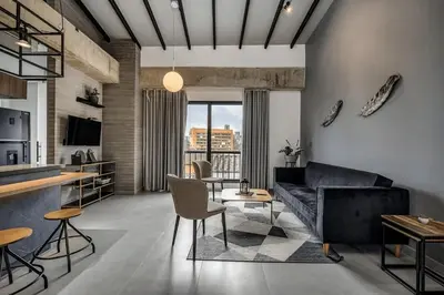 a living room with a couch and a table at Poblado, 5 min to San Lucas Plaza, Free parking 315 in Medellín
