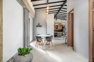 a dining room and living room with a table and chairs at Poblado, 5 min to San Lucas Plaza, Free parking 315 in Medellín