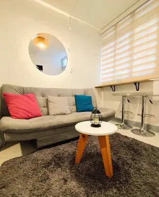 a living room with a couch and a table at Laureles estadio plaza mayor la 70 unicentro in Medellín