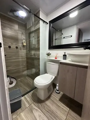 a bathroom with a toilet and a sink and a shower at Apartamento familiar y agradable in Manizales