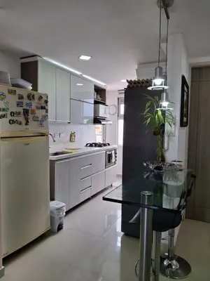 a kitchen with a refrigerator and a table in it at RentalsOP AN09 Apartamento en Laureles el barrio mas cool del mundo, moderno, con balcon y excelente vista in Medellín