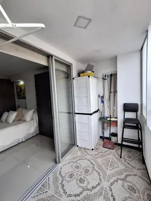 a bedroom with a bed and a chair in it at RentalsOP AN09 Apartamento en Laureles el barrio mas cool del mundo, moderno, con balcon y excelente vista in Medellín