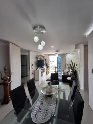a living room with a glass table and chairs at RentalsOP AN09 Apartamento en Laureles el barrio mas cool del mundo, moderno, con balcon y excelente vista in Medellín