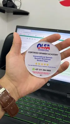 a person holding a cd in front of a laptop at Tu hogar temporal en Medellín, Moderno, cómodo, bien ubicado y WIFI 400 in Medellín