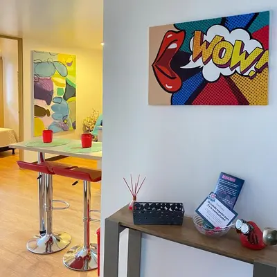 a room with a table and a painting on the wall at Tu hogar temporal en Medellín, Moderno, cómodo, bien ubicado y WIFI 400 in Medellín