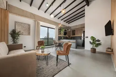 a living room with a couch and a table at Poblado, 5 min to San Lucas Plaza, Free parking 316 in Medellín