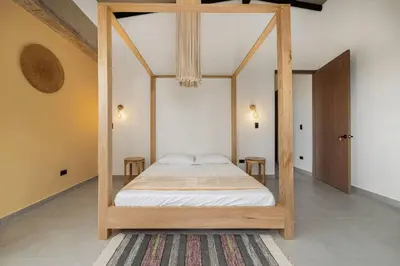 a bedroom with a canopy bed with two tables at Poblado, 5 min to San Lucas Plaza, Free parking 316 in Medellín