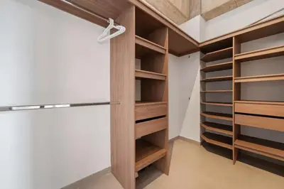 a closet with wooden shelves and a refrigerator at Poblado, 5 min to San Lucas Plaza, Free parking 316 in Medellín