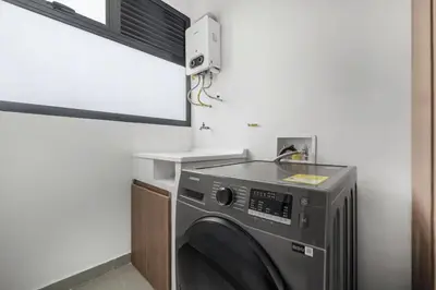 a washing machine in a room with a window at Poblado, 5 min to San Lucas Plaza, Free parking 316 in Medellín
