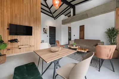 a living room with a wooden table and chairs at Poblado, 5 min to San Lucas Plaza, Free parking 316 in Medellín