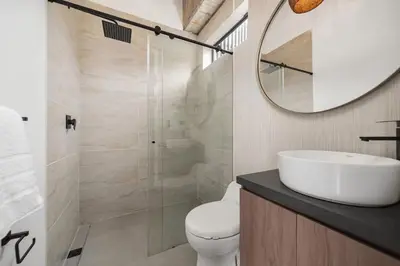 a bathroom with a toilet and a sink and a mirror at Poblado, 5 min to San Lucas Plaza, Free parking 316 in Medellín
