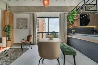 a living room with a table and a kitchen at Poblado, 5 min to San Lucas Plaza, Free parking 316 in Medellín