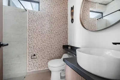 a bathroom with a white toilet and a mirror at Poblado, 5 min to San Lucas Plaza, Free parking 316 in Medellín