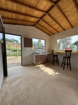 a kitchen with two chairs and a table in a room at Mariposa 1 in Sopetran