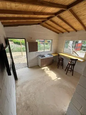 a kitchen with a table and two chairs in a room at Mariposa 1 in Sopetran
